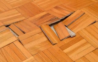 Buckled hardwood floor damaged by water