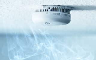 Smoke and smoke detector on a ceiling