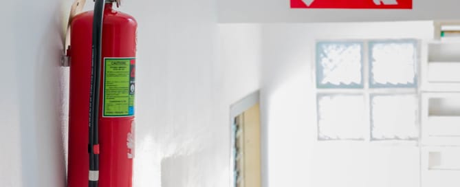 Fire extinguisher next to a fire escape in a commercial building