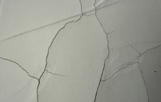 Concrete wall with cracks in it