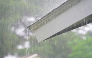 Rain running off the roof of a home