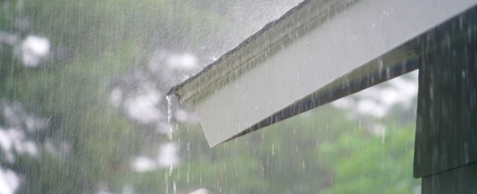Rain running off the roof of a home